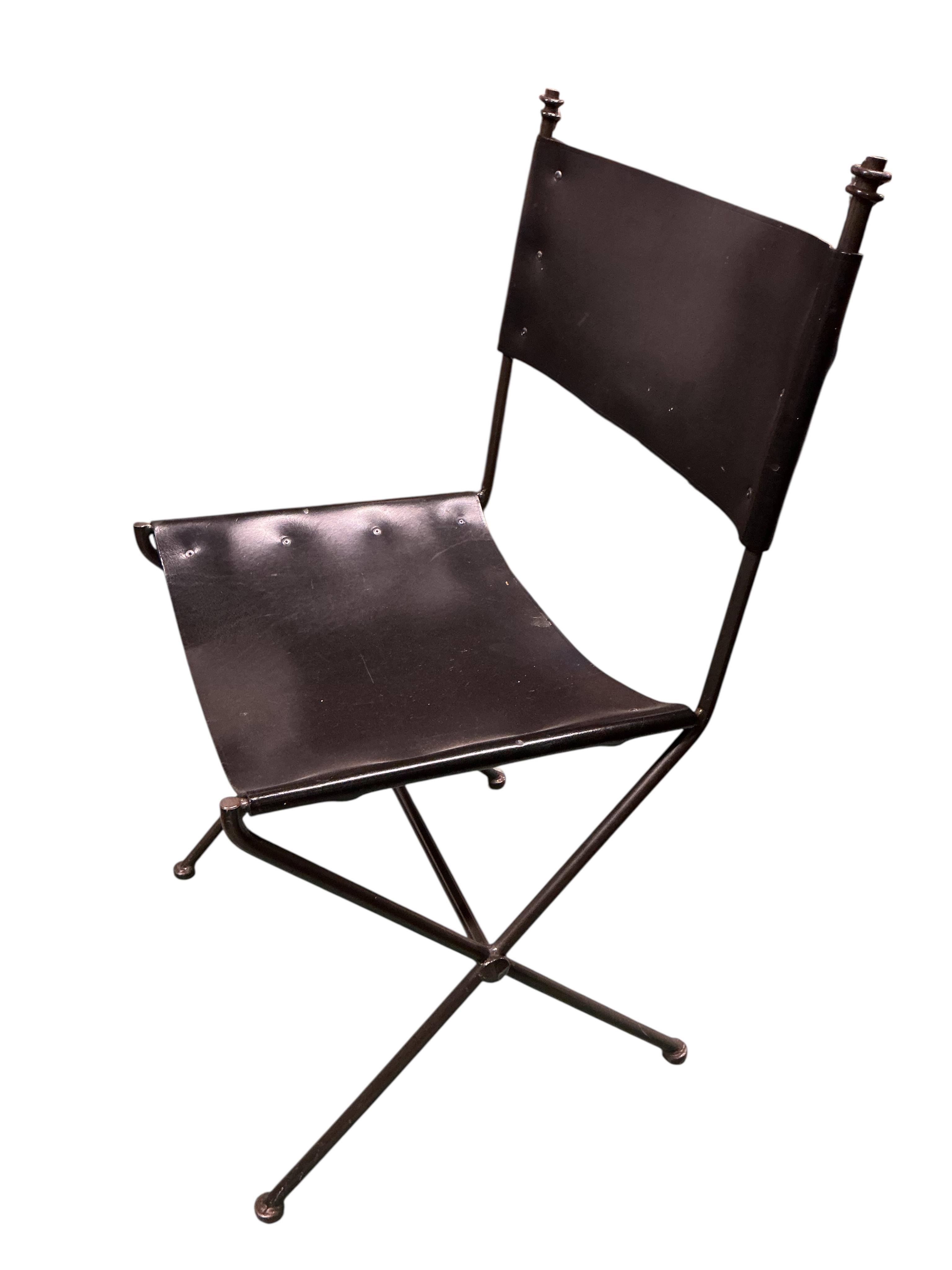 A set of seven mid century wrought iron leather chairs with 'X' frame stretchers, two with arms, width 55cm, depth 50cm, height 90cm